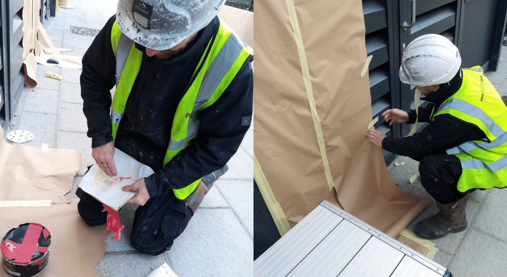 A damage repair worker carrying out repairs on the side of a building during his NVQ Level 2 in Damage Repair and Resurfacing