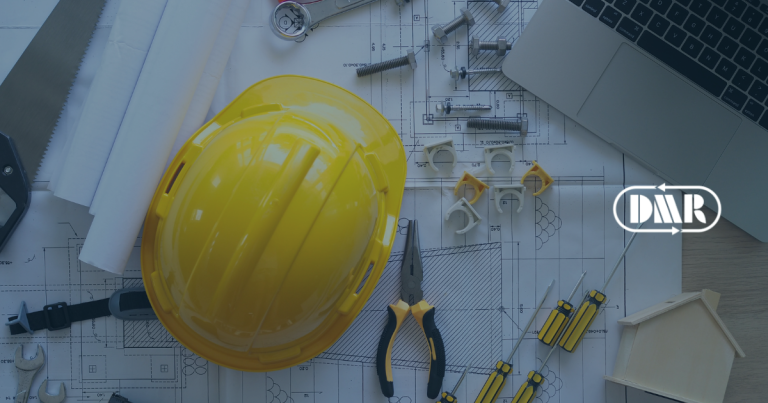 A builder's helmet on a workbench with design plans
