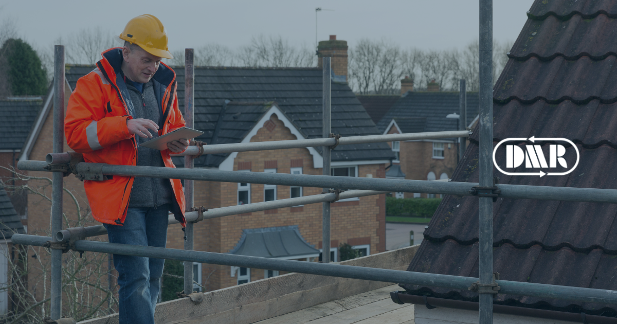 Construction worker stood on scaffolding with a workplace Ipad