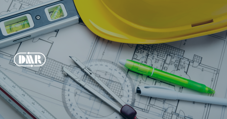 construction hard hat, compass, ruler and architectural plans on a table