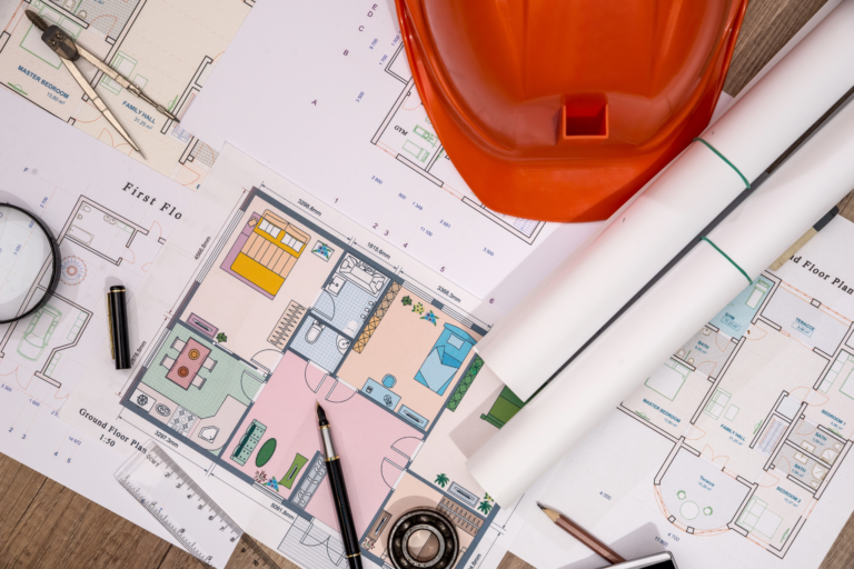 Construction funding and planning notes on a table with small building equipment around it.